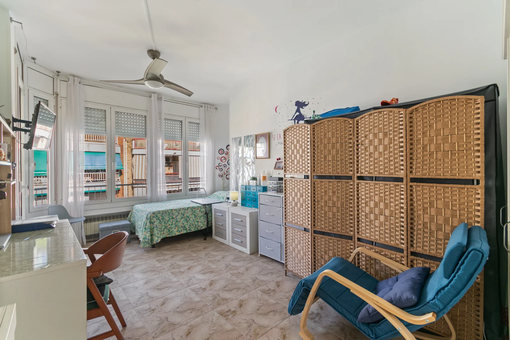 Wide view of the bedroom with a desk area